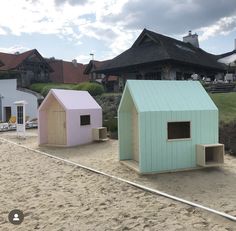 there are two small houses on the beach