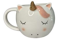 a white ceramic mug with a pink horn on it's head and eyes painted to look like a unicorn