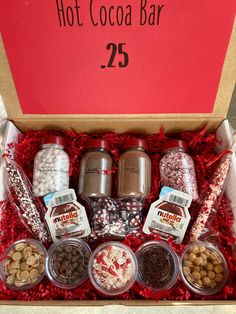 the hot cocoa bar gift box is packed with nuts, chocolates and other treats