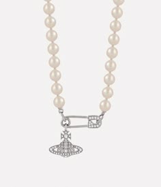 Pearls are a key element of the house’s iconography, symbolising a sense of luxury and rebellion. The Lucrece Pearl necklace features a strand of glass-based pearls, highlighted by a crystal-encrusted orb that dangles from a safety pin charm. This timeless safety pin motif, a symbol of non-conformity, reflects Vivienne’s iconic punk-inspired approach. Bougie Closet, Vivian Westwood, Fashion Vision Board, Fire Jewelry, Punk Inspiration, String Of Pearls, Clothes Hangers, Gold Pearl Necklace, Pin Pendant