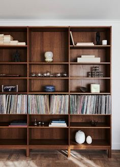 a wooden bookcase filled with lots of records