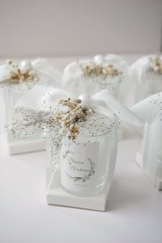 small white boxes with flowers and ribbons on them