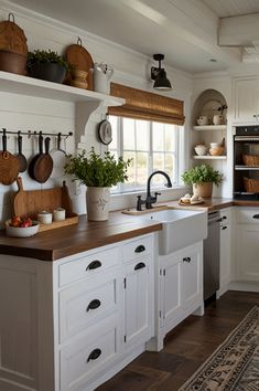 a kitchen with white cabinets and wooden counter tops