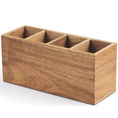 a wooden box with four compartments in it