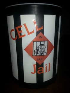 a black and white bucket with an orange logo on the side that says cell in jail