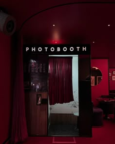 a photo booth with red curtains and lights