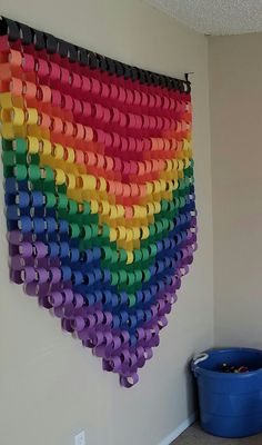 a multicolored wall hanging made out of toilet paper