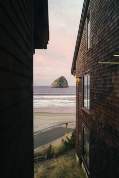 an ocean view from the outside of a house with a beach in the back ground