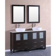 two sinks and mirrors in a bathroom with beige walls, dark wood cabinets and white counter tops