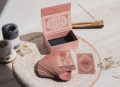 an open pink box sitting on top of a wooden table