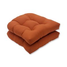 two orange cushions sitting on top of each other