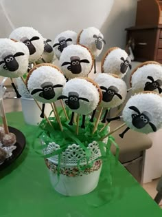 there are many desserts made to look like sheep in the grass and on sticks