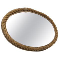 a round rope mirror hanging on the wall