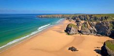 an aerial view of the beach and cliffs at low tide bay, near porthloe