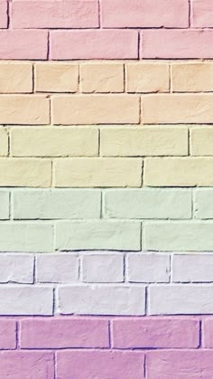 a multicolored brick wall with pastel colors