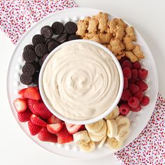 a white plate topped with fruit and dip