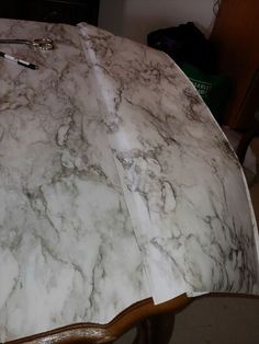 a marbled table top with some scissors on it