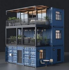 a building made out of shipping containers with balconies and plants on the balcony