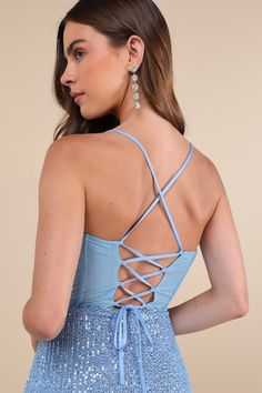 Your dazzling presence will be seen from any angle on the dance floor with a look like the Lulus Bold Aesthetic Blue Sequin Lace-Up Bodycon Mini Dress! Shimmering blue sequins decorate a mesh overlay (atop a matching knit liner) that shapes a sleeveless bodice with sheer mesh paneling at the back and supportive boning, a straight neckline, and slender straps that create a trendy lace-up design. The fitted waist tops a sexy bodycon skirt that ends at a flirty, notched mini hem. Hidden back zipper Blue Evening Dress With Corset Back For Gala, Blue Evening Dress With Corset Back And Fitted Bodice, Glamorous Light Blue Fitted Evening Dress, Glamorous Fitted Light Blue Evening Dress, Blue Evening Dress With Sweetheart Neckline And Corset Back, Blue Evening Dress With Corset Back, Blue Prom Evening Dress With Corset Back, Blue Evening Dress With Boned Bodice For Prom, Blue Dress With Corset Back For Gala