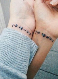 two people holding hands with the words friends forever written on them