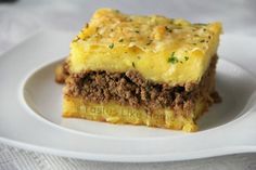 a piece of meat and cheese cake on a white plate