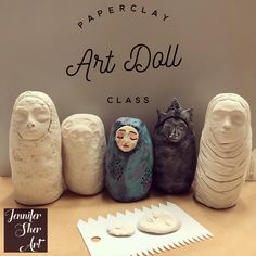 clay art dolls are lined up in front of a sign that says paperclay art doll class