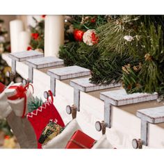 stockings hung on the mantle with candles and christmas decorations