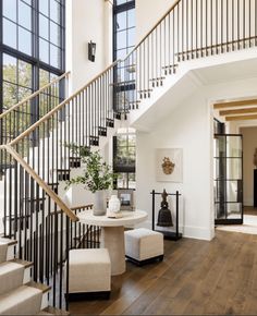 an image of a staircase in a house with wood flooring and white paint on the walls