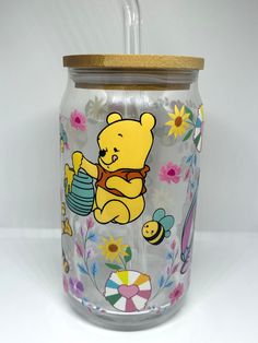 a glass jar with winnie the pooh on it