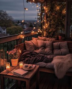 a couch sitting on top of a wooden floor next to a table filled with candles