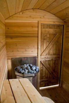 the inside of a sauna with wood walls and doors