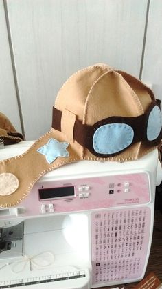 a hat sitting on top of a sewing machine