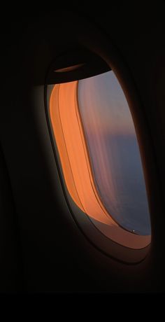 an airplane window looking out at the ocean