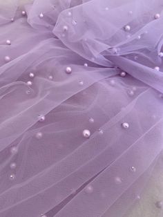 purple tulle with white pearls on it