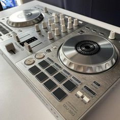 a silver dj controller sitting on top of a table