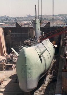 a large white submarine sitting on top of a dry dock