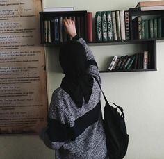 a person standing in front of a book shelf