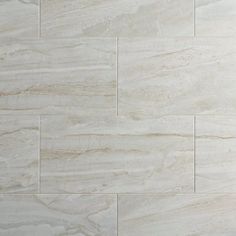 a white marble tile wall that looks like it has been polished