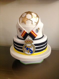 a cake that is sitting on top of a table with a soccer ball in the center