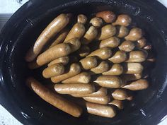 some sausages are cooking in a black pan