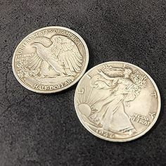 two american silver eagle coins on a black surface