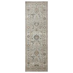 a long rug with an ornate design on the bottom and sides, in grey tones