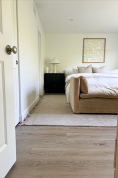 a bed sitting in the middle of a bedroom next to a doorway