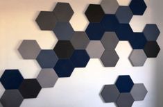 the wall is made up of hexagons in different colors and sizes,