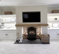 a living room filled with furniture and a flat screen tv mounted above a fire place