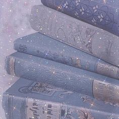 a stack of books sitting next to each other on top of a floor covered in stars