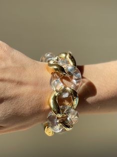 18k gold and crystal large link bracelet by Seaman Schepps. DESIGNER: Seaman Schepps MATERIAL: 18k Gold GEMSTONES: Crystal DIMENSIONS: Bracelet is 8 1/8" long end to end, approx. wearable length is 7-7.5", width 30mm. MARKED/TESTED: 1959, Seaman Schepps, Shell mark, 750. WEIGHT: 113.1 grams. CONDITION: Previously Owned, Excellent Condition. Luxury Solid Link Jewelry For Parties, Luxury Chain Link Party Bracelets, Luxury Chain Link Bracelets For Parties, Clear Bracelet Jewelry For Party, Modern Chunky Chain Bracelets For Party, Elegant Clear Bangle Jewelry, Modern Clear Bracelet Jewelry, Modern Lucite Bangle Jewelry, Clear Lucite Party Jewelry