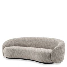 an oval shaped couch sitting on top of a white floor