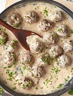 a pan filled with meatballs covered in gravy