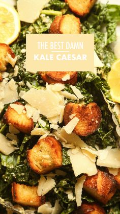 the best damn kale caesar with parmesan cheese and lemons on top